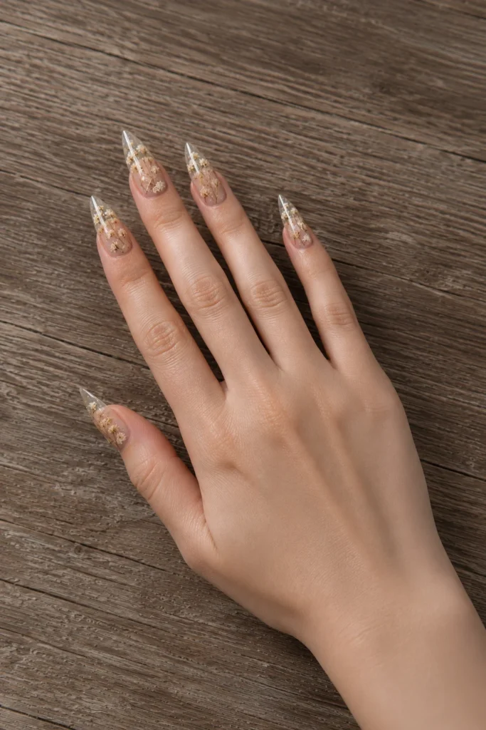 Clear gel pointy nails with pressed dried flowers inside