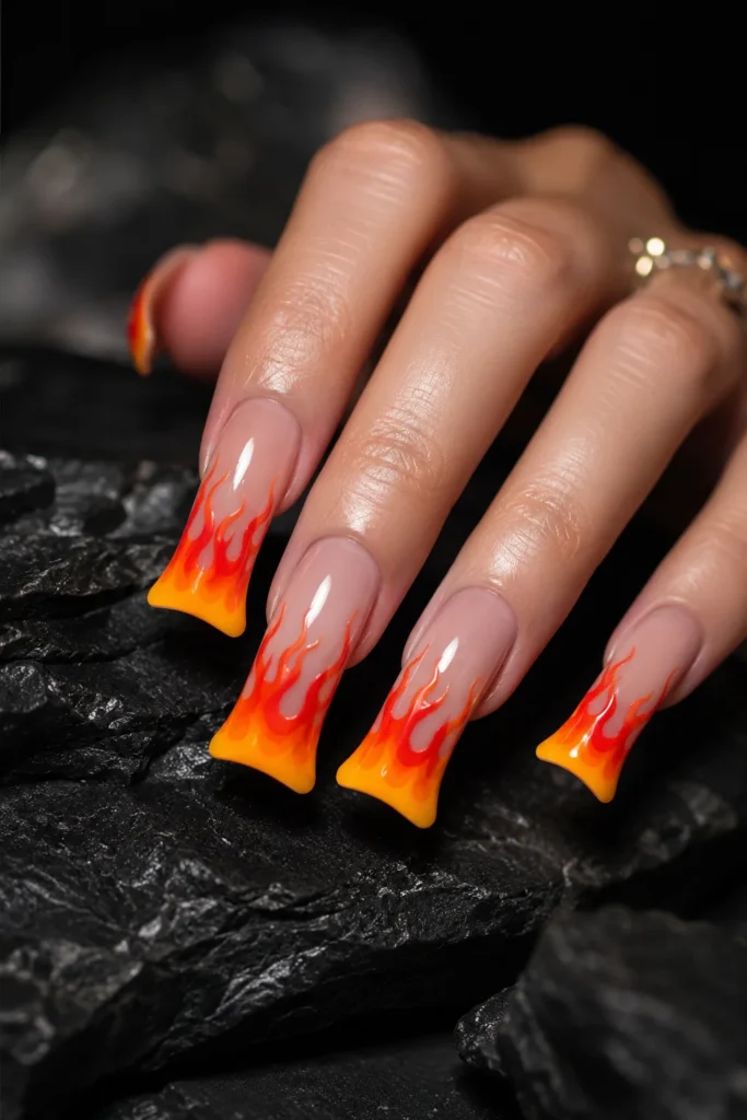 Long duck nails featuring colorful flame nail art