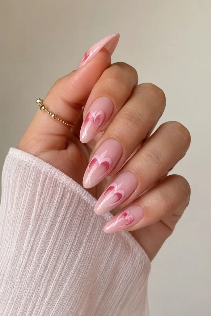 almond shaped nails with glossy pink heart designs