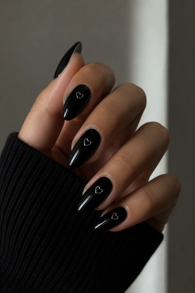glossy black nails with white silver heart accents
