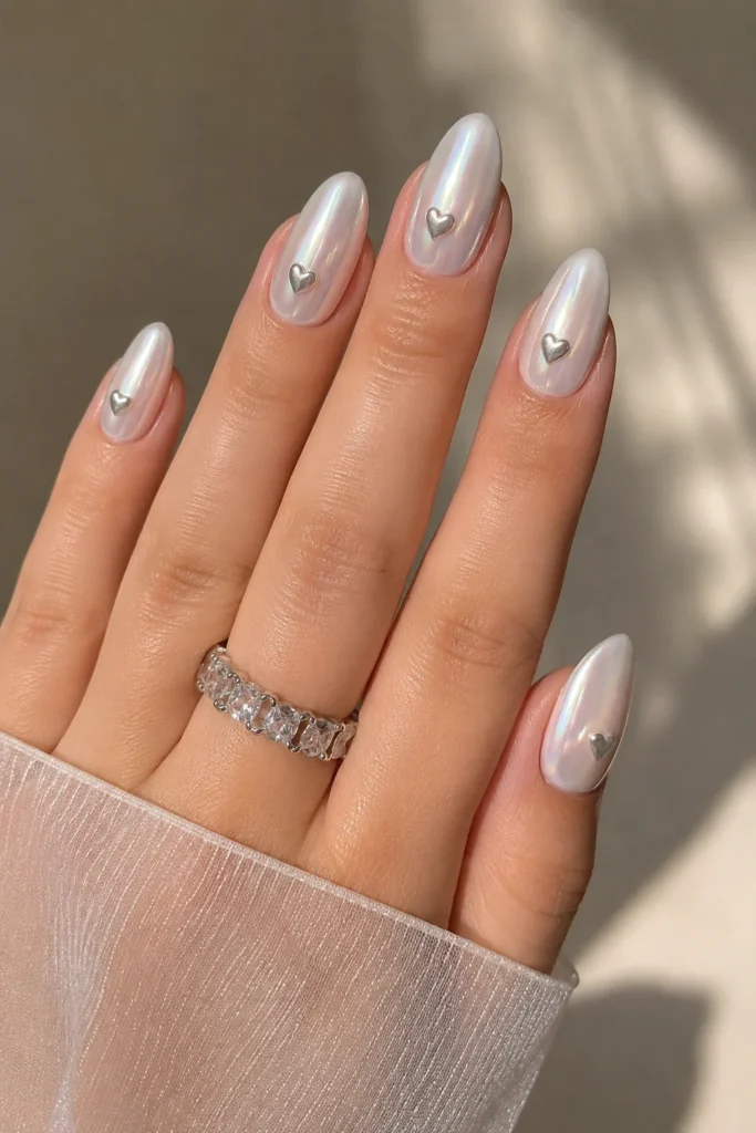 pearl chrome nails with metallic heart accents