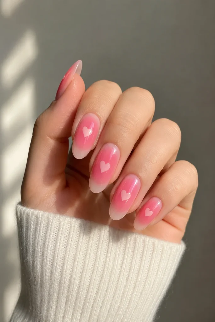 pink aura nails with subtle heart accents