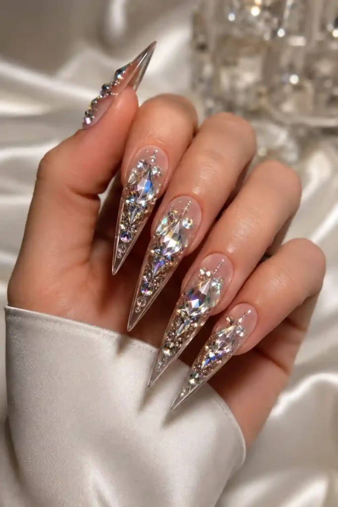 Long sharp stiletto nails with dramatic crystal gemstone placement