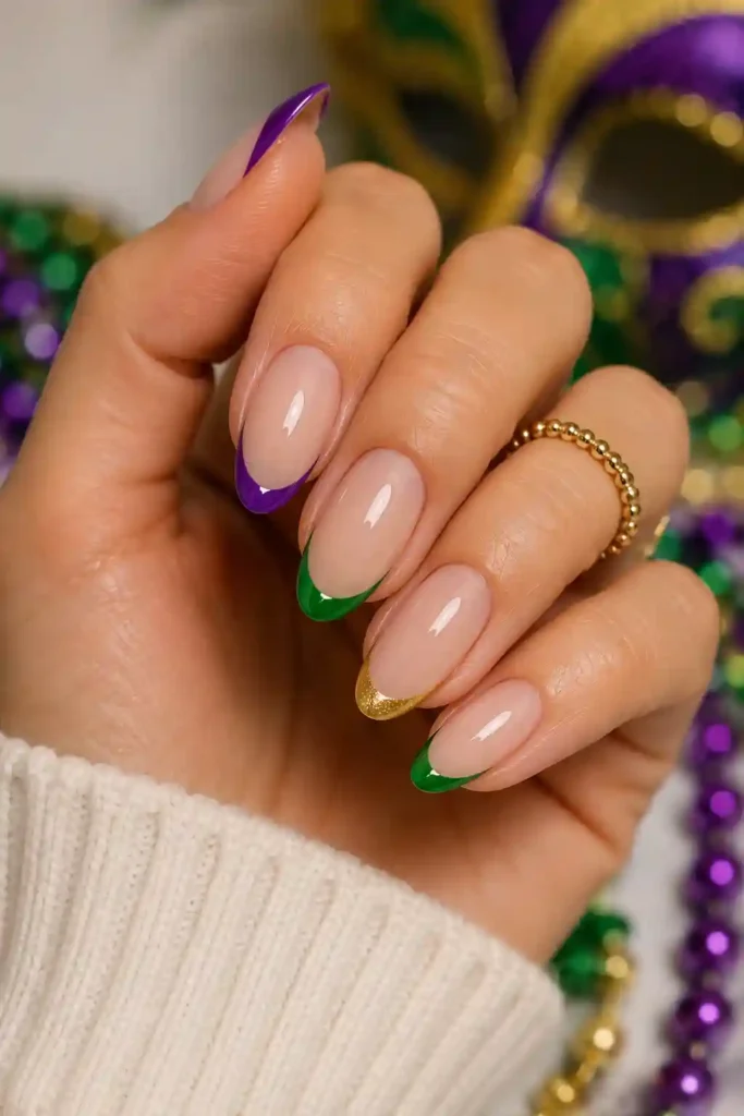 French tip nails with purple green and gold carnival accents