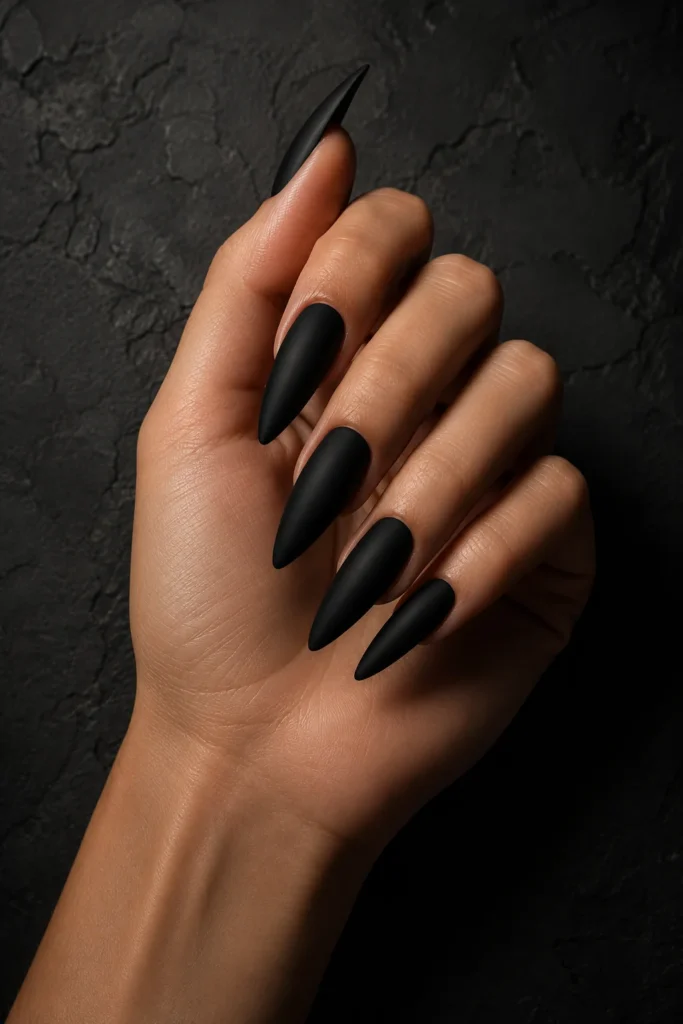 Matte black pointy nails with bold sharp stiletto shape