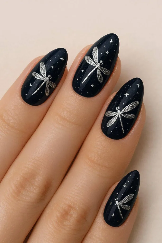 Navy nails with silver dragonflies and tiny stars