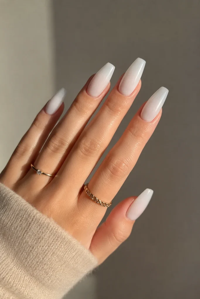 Milky white ballerina nails with a soft sheer glossy finish