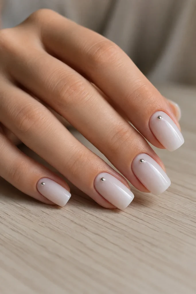 Milky white squoval nails with silver studs