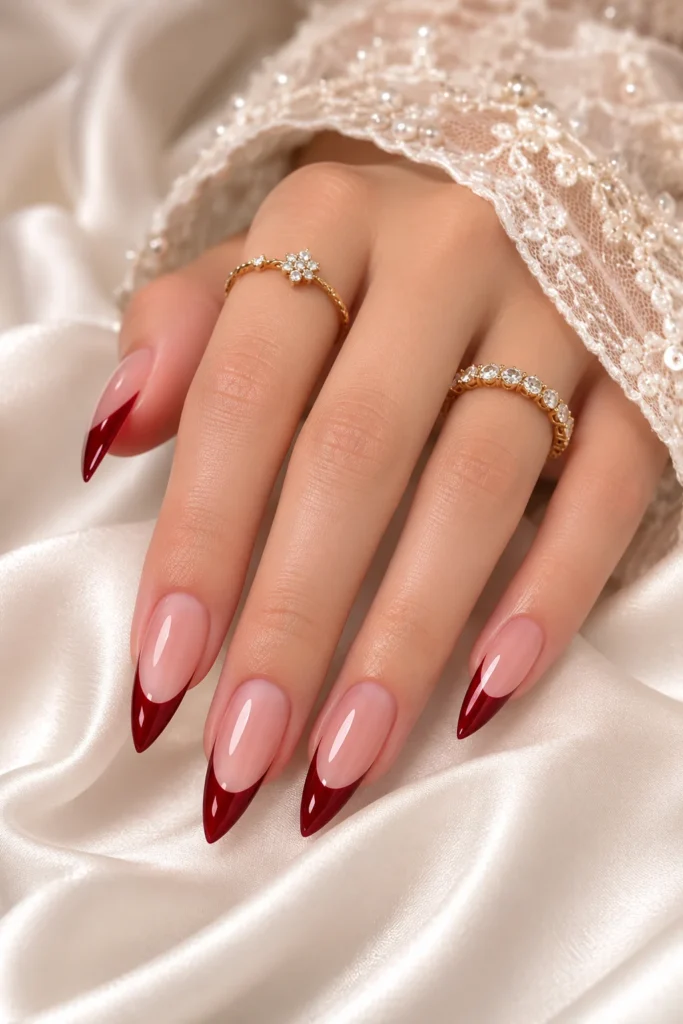Modern French tip pointy nails with angled burgundy tips