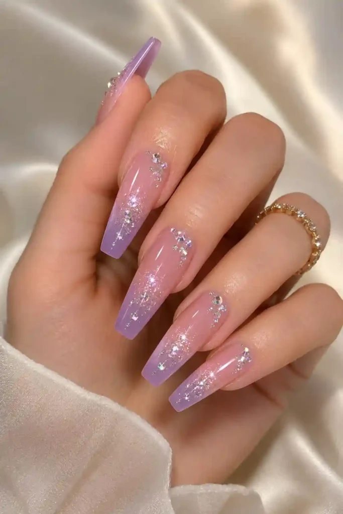 Soft ombre gradient nails finished with sparkling gemstone accents