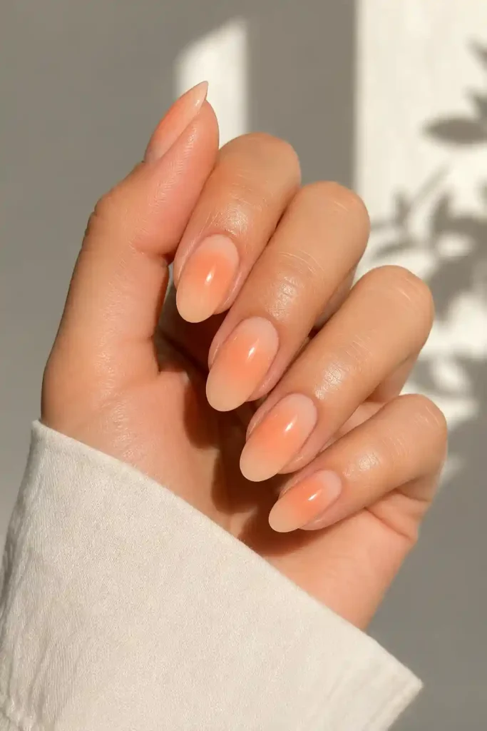 Warm peach aura nails glossy finish spring nail design