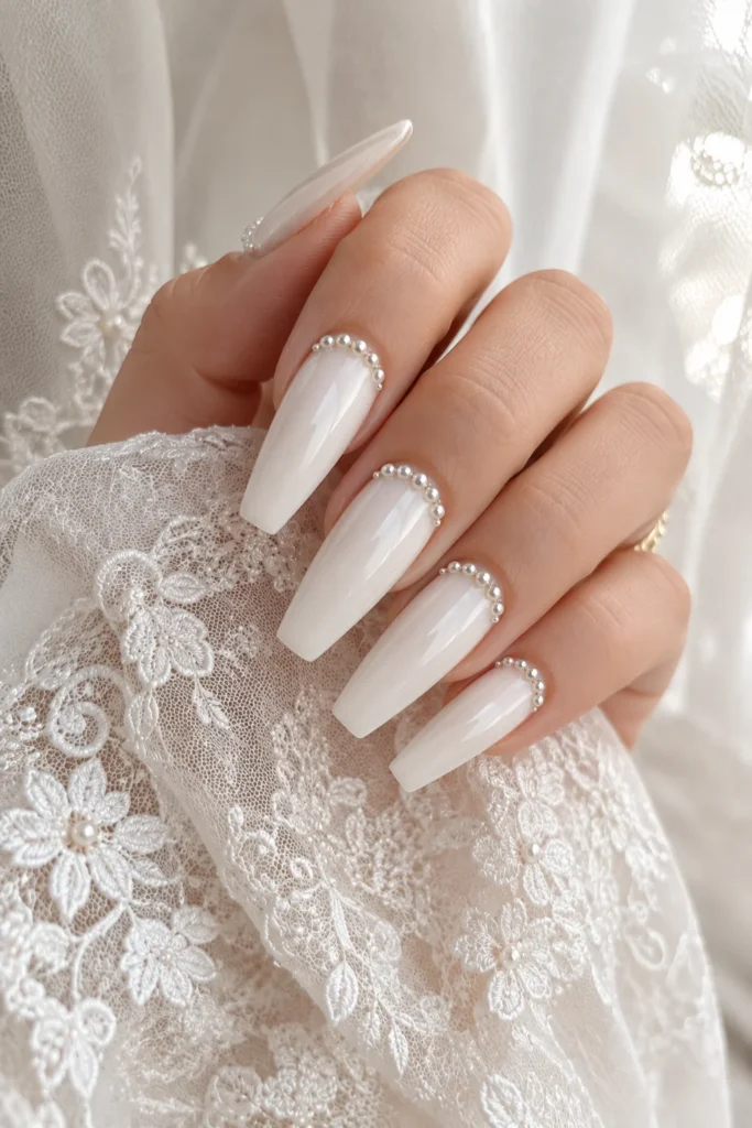 Ivory ballerina nails with pearl embellishments