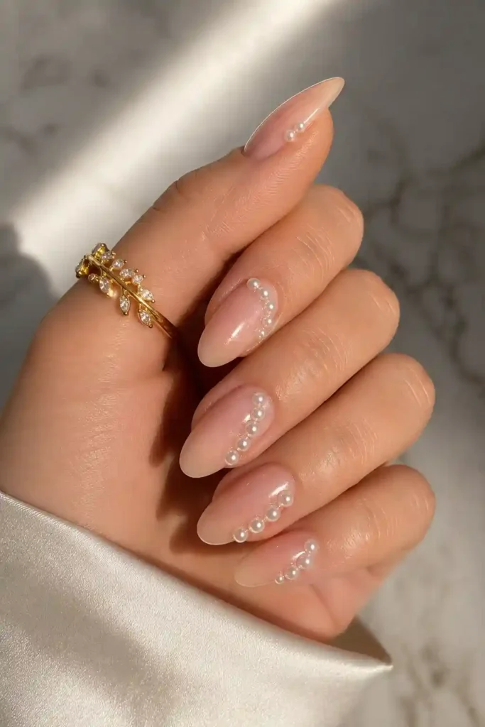 Elegant nails decorated with delicate pearl embellishments