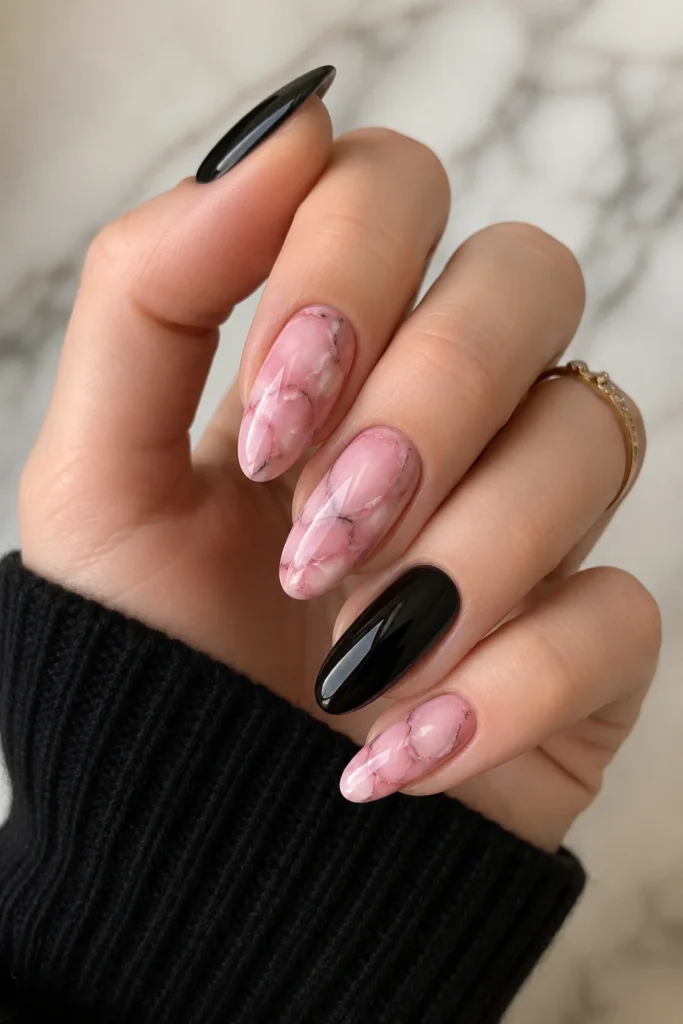 Pink marble effect nails with black accent nail