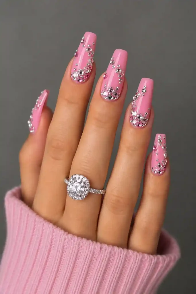 Glossy pink nails with dazzling rhinestone gemstone clusters