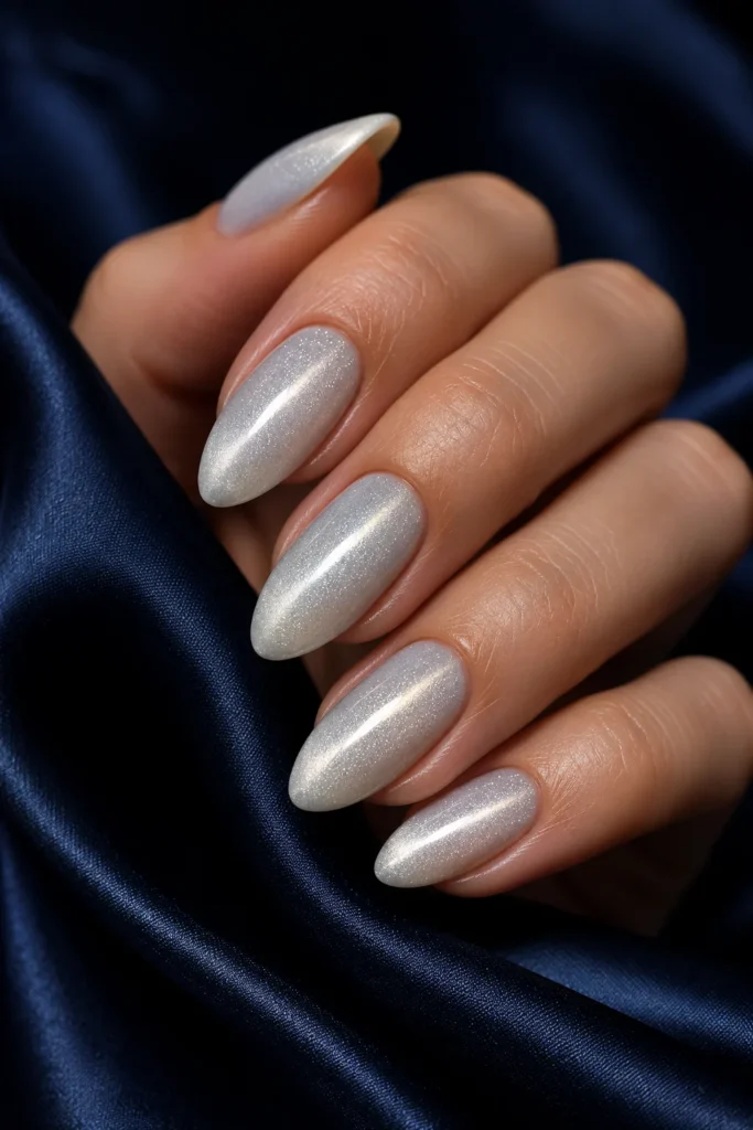 White almond nails with silver cat eye shimmer