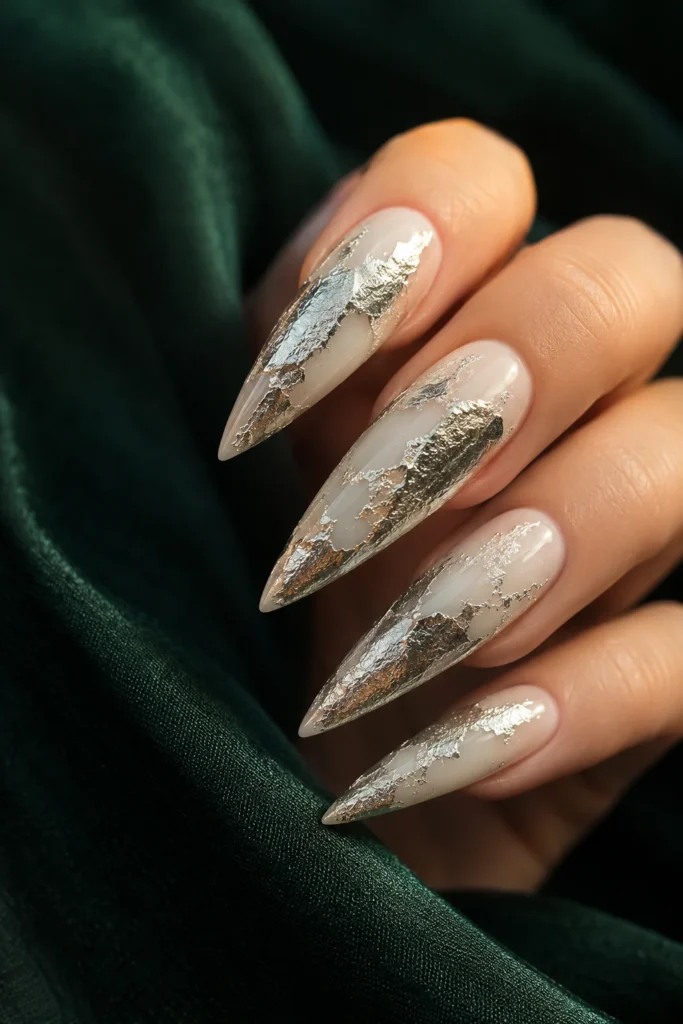 Milky white stiletto nails with silver leaf