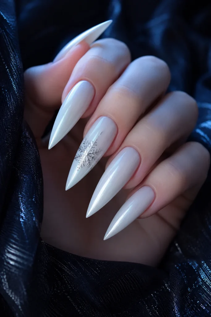 White stiletto nails with silver snowflake accent