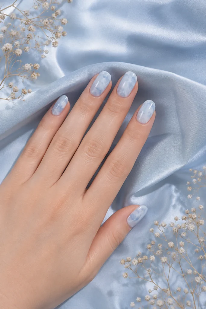 Soft blue cloud marble nails with white swirls