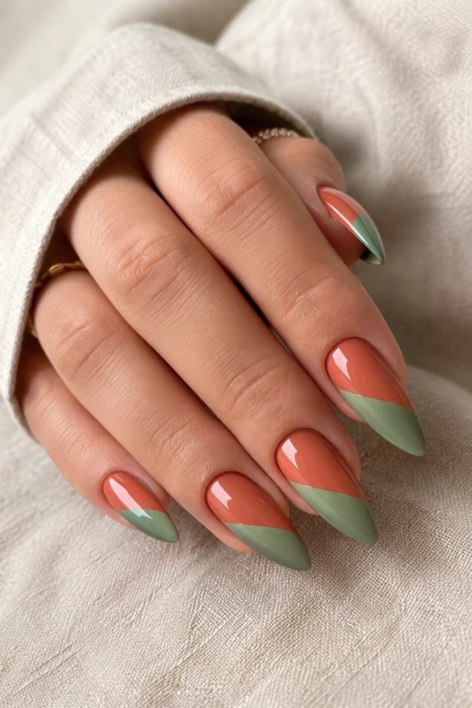 Two-tone diagonal split pointy nails in terracotta and sage green
