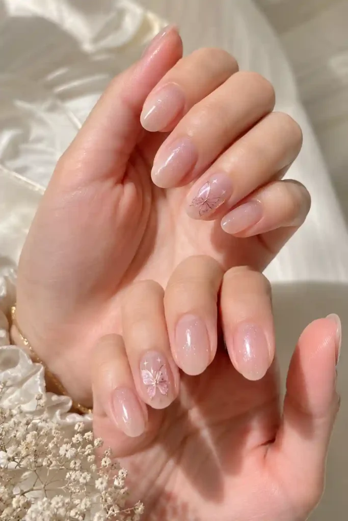 Whimsical tiny butterfly nail art on soft pastel spring base