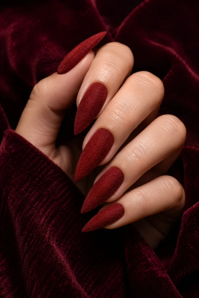 Deep red velvet effect pointy nails with soft textured finish