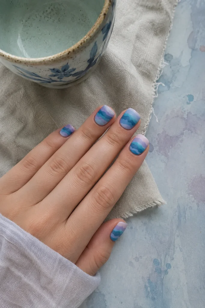 Watercolor wave nail art blending soft coastal shades