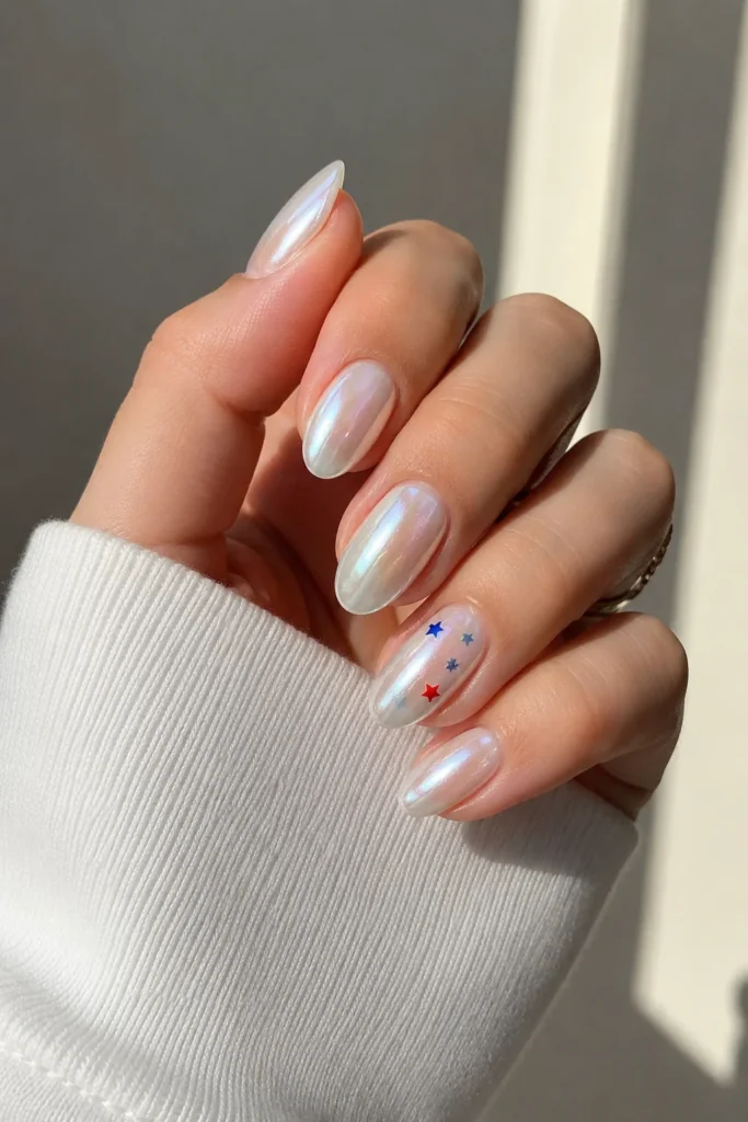 Soft pearl white chrome nails with patriotic accent