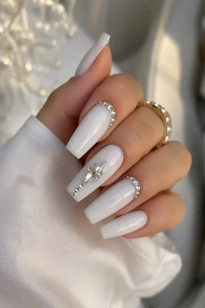 Milky white nails with elegant sparkling crystal rhinestone accents