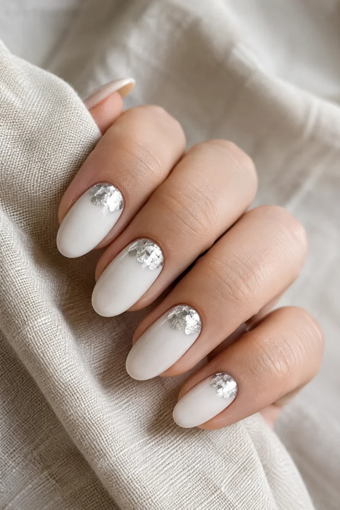 White oval nails with silver foil accents