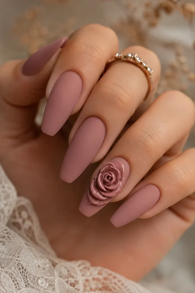 Mauve matte nails with raised 3D rose accent on ring finger