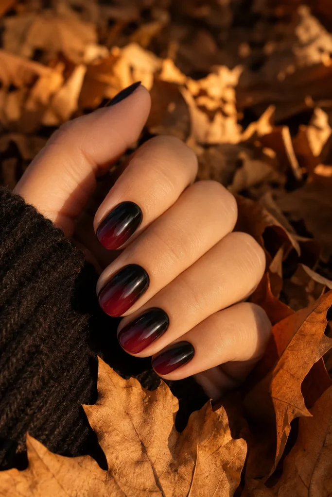 Black to burgundy ombre Halloween nails with a glossy gradient finish