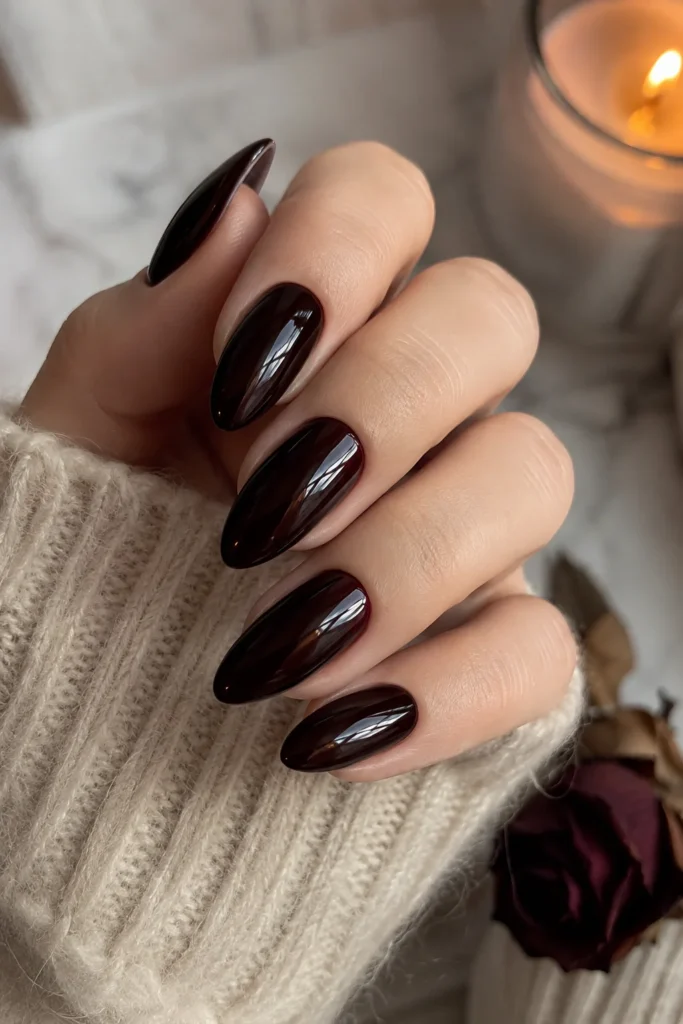 Black cherry glossy almond nails in a deep red shade