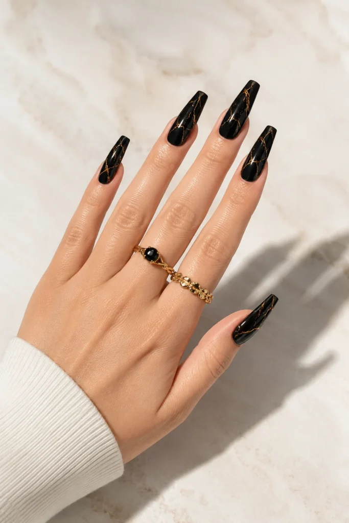 Black marble nails with thin gold vein lines