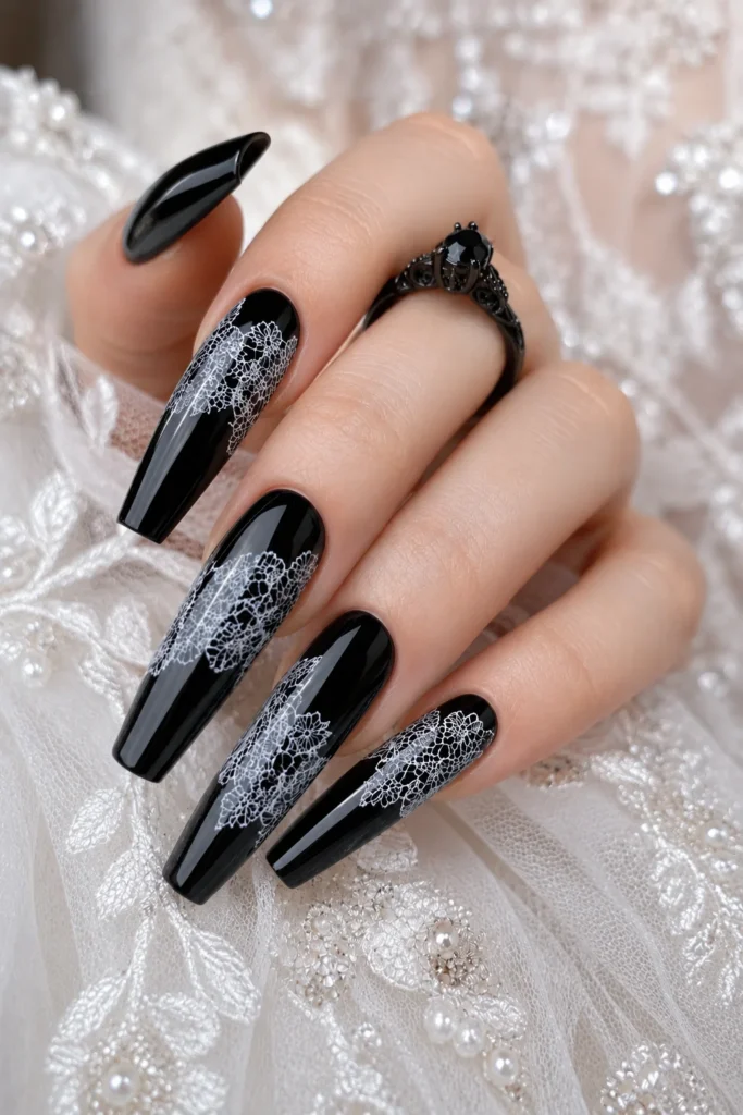 Black wedding nails featuring intricate white lace-inspired nail art