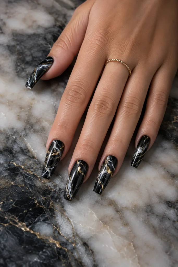 Black marble swirl nails with white and gold accents