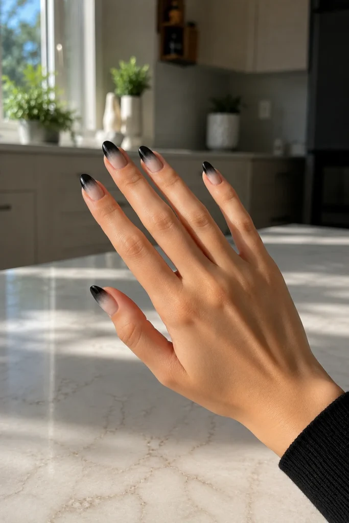 Black milky ombré nails fading from white to black