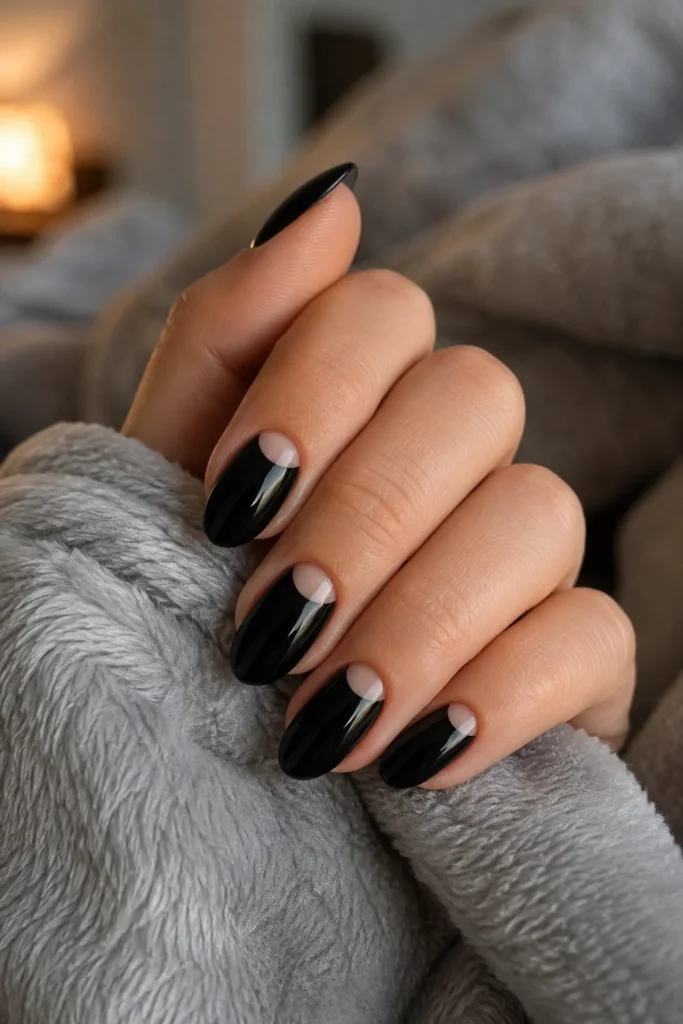 Short black nails with a negative space crescent moon design
