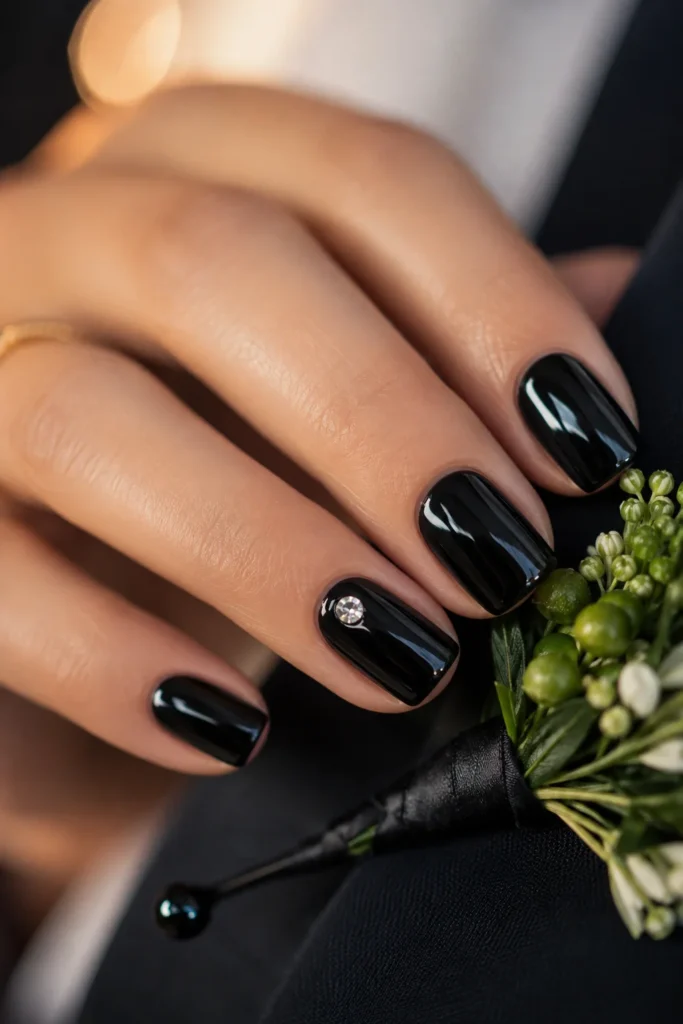 Glossy black wedding nails with a jeweled statement ring finger