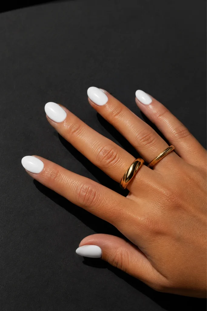 Bright glossy white manicure on short almond nails
