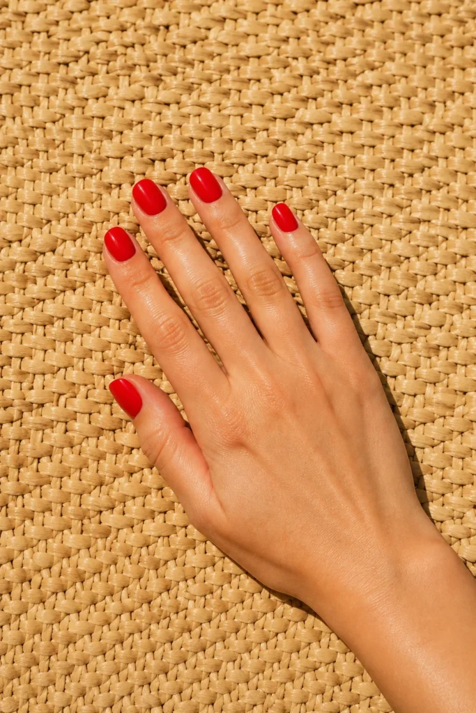 Bright poppy red wedding nails on short rounded nails