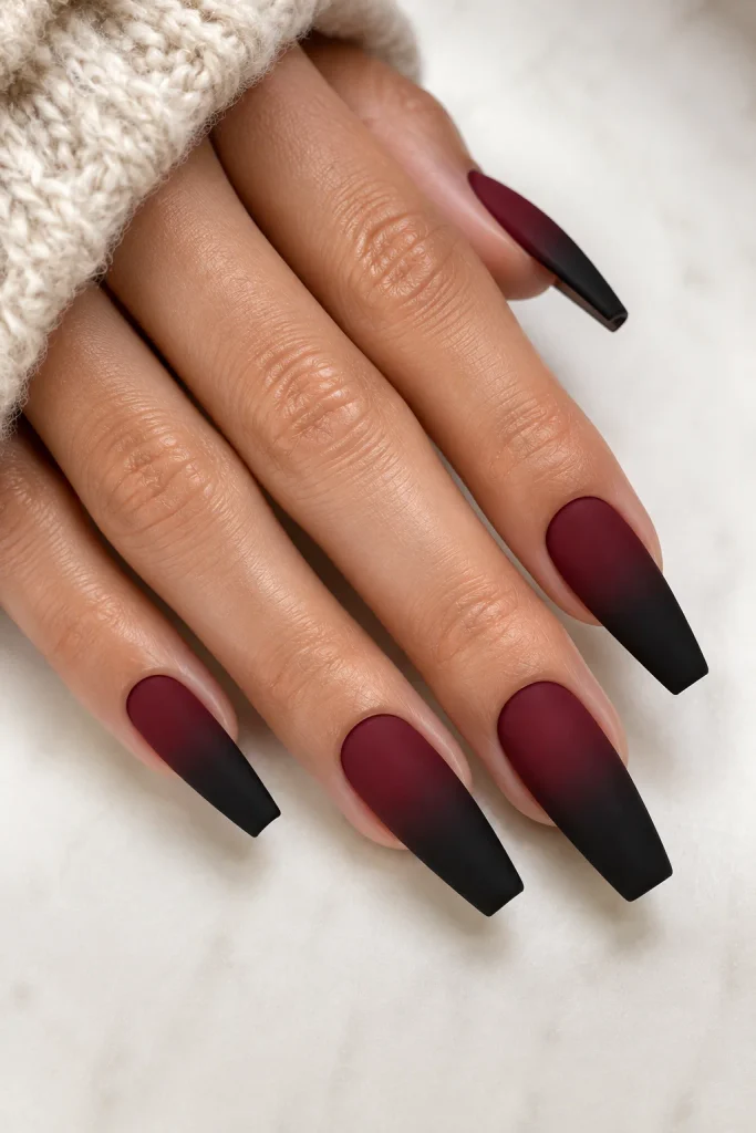 Deep burgundy ombre nails fading into black tips