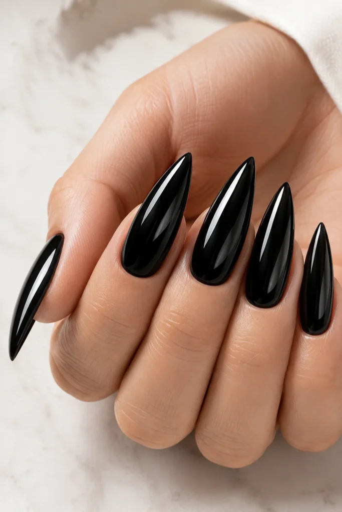 Classic glossy black stiletto nails with high shine