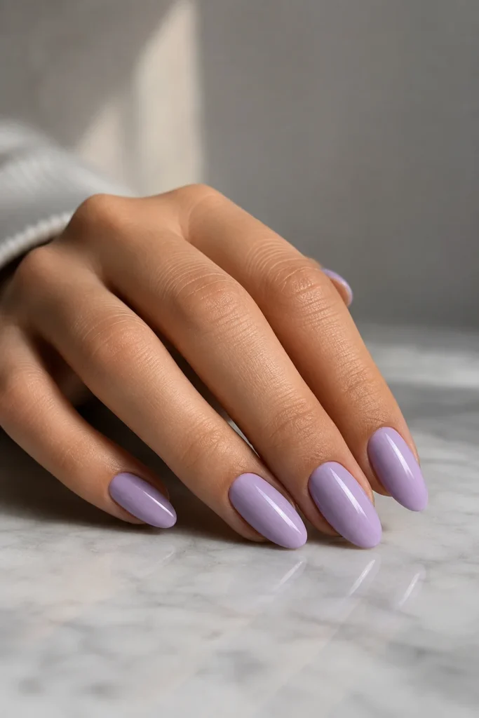 Classic glossy lilac nails on almond-shaped manicure with a smooth high-shine finish
