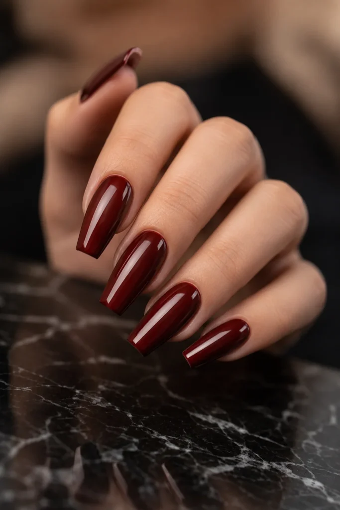 Classic glossy oxblood coffin nails with a high-shine dark red finish