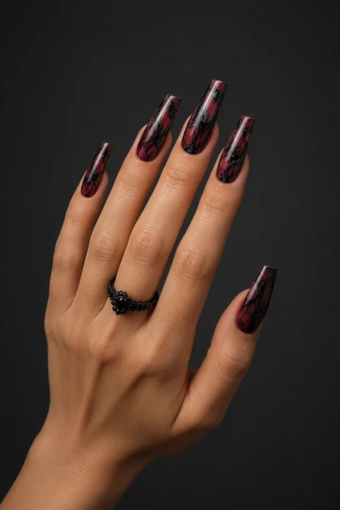 Dark red coffin nails featuring elegant black marble details