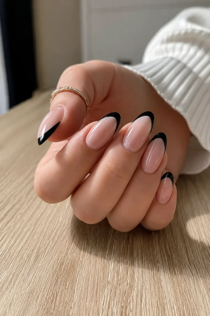 Short nude nails with deep black French tips