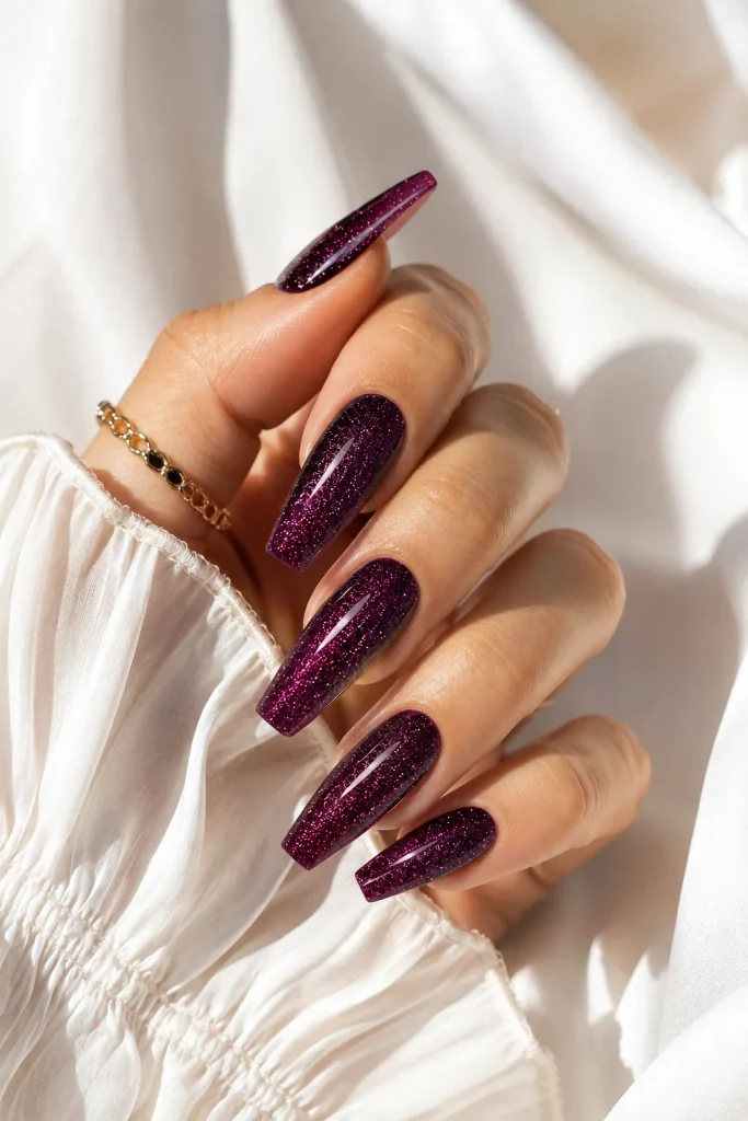 Deep plum glitter nails with a rich evening finish