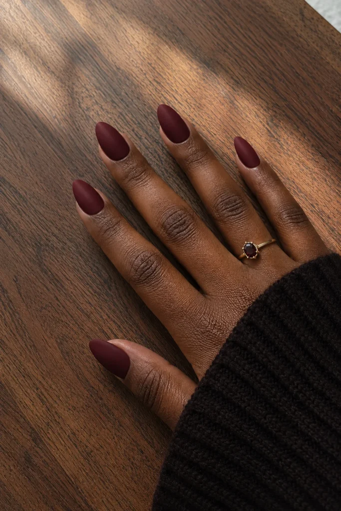 Deep wine red matte nails on dark skin