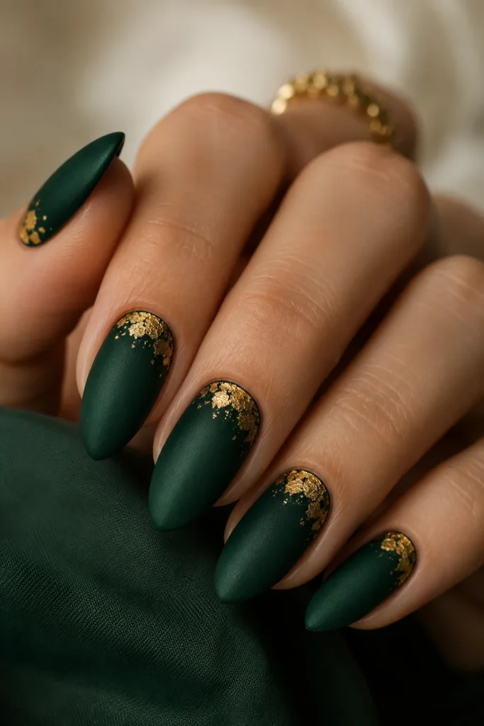 Matte emerald green almond nails with gold foil cuticle accents
